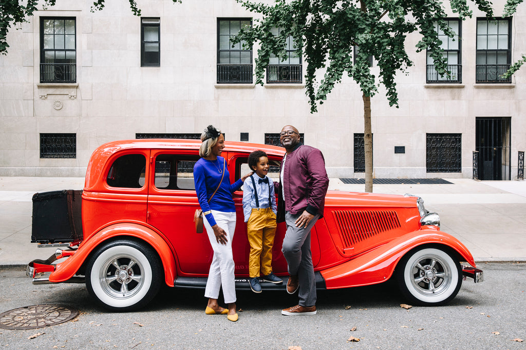 family in front of vintage car 