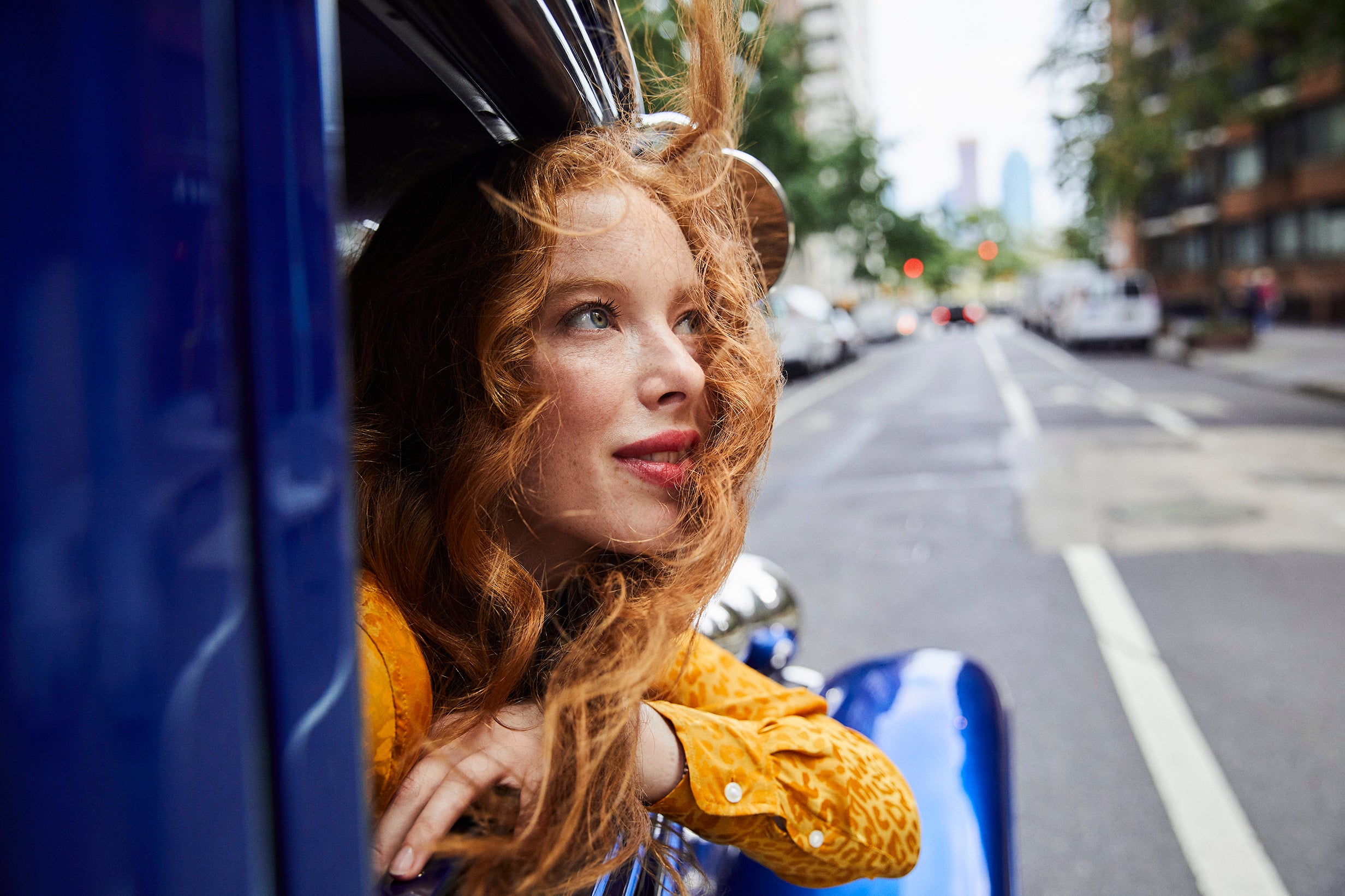 woman looking out of a vintage car